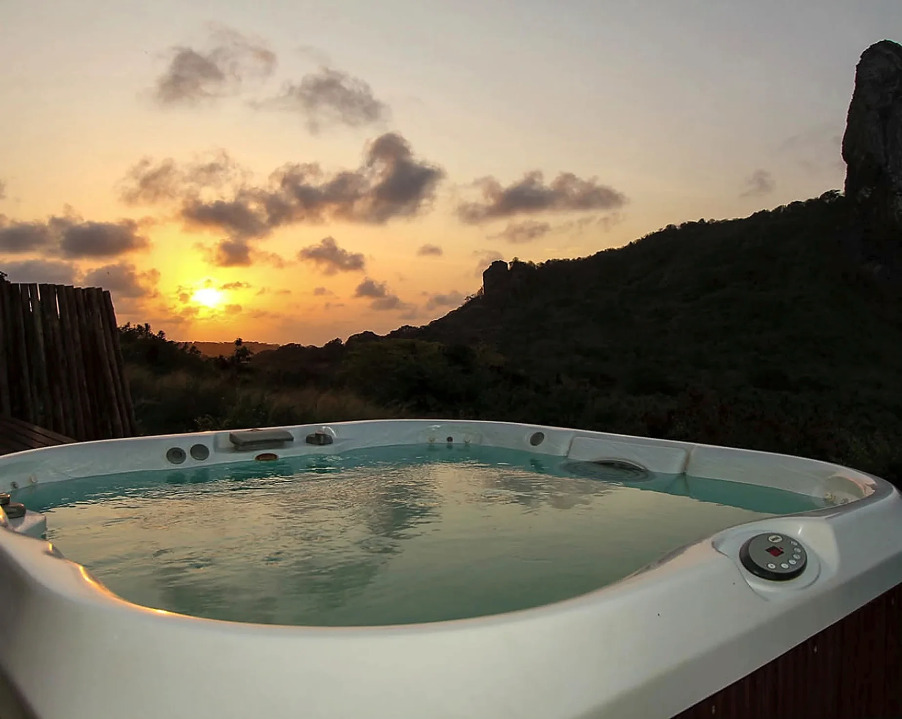Private hot tub at sunset in the Master Bungalow